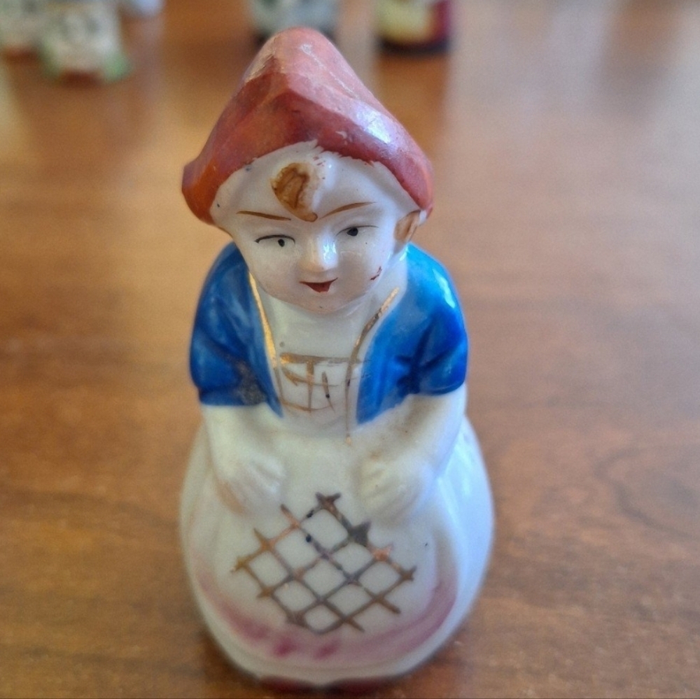 Charming Ceramic Figurine with Red and Blue Accents